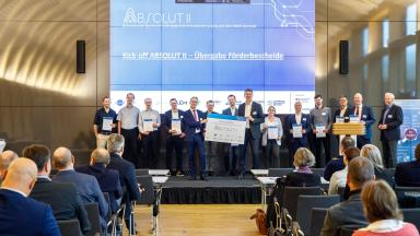 Group photo of all representatives of the ABSOLUT II project holding a funding certificate