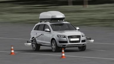 A car with a tilting frame and sensors on the left and right of the doors.