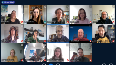 People on a screen in a video conference.