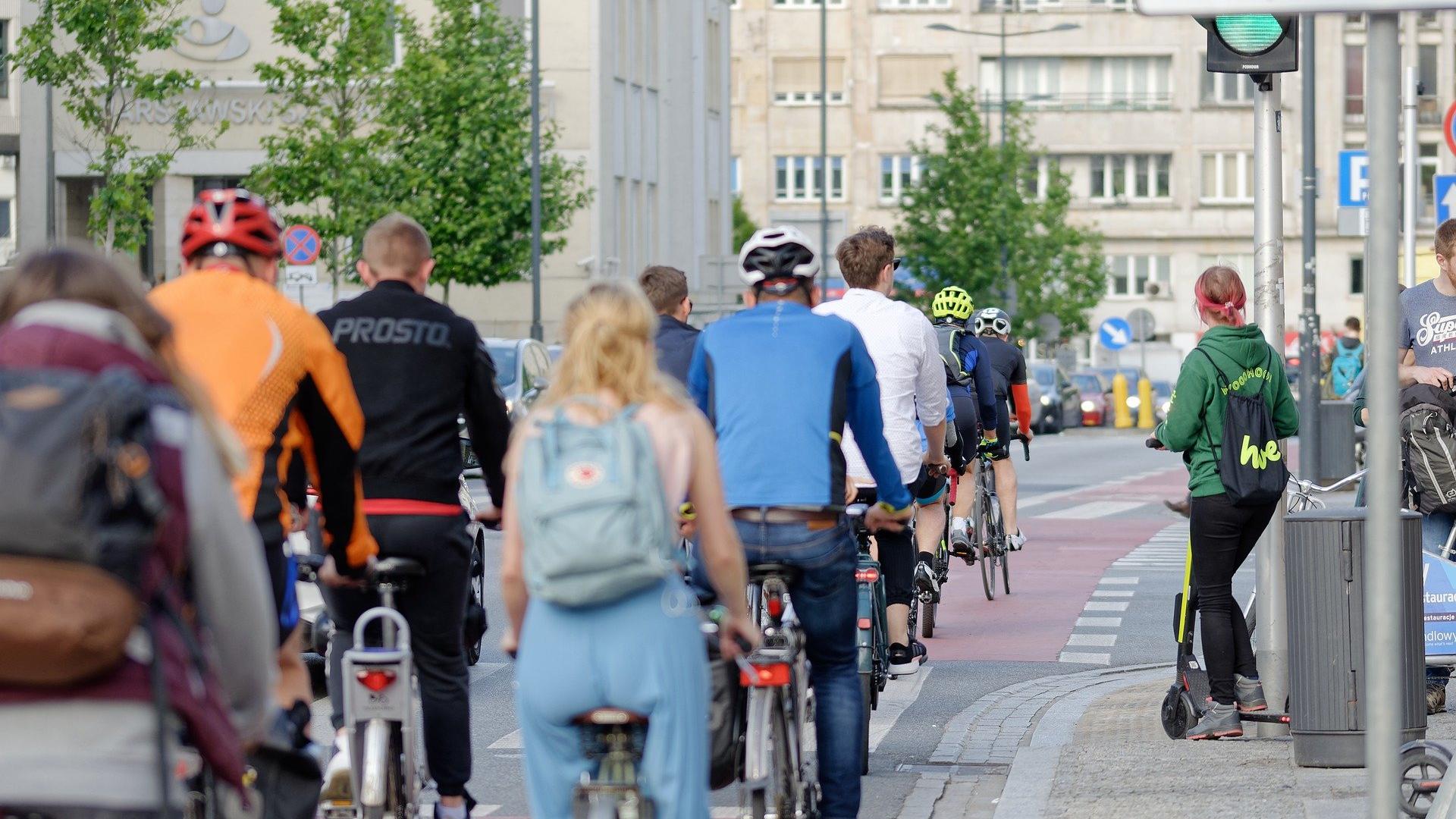 A group of cyclists in the city from behind