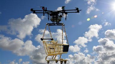 Flying drone with shopping trolley attached below