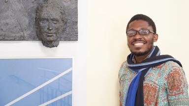  A man stands next to a wall relief by Friedrich List