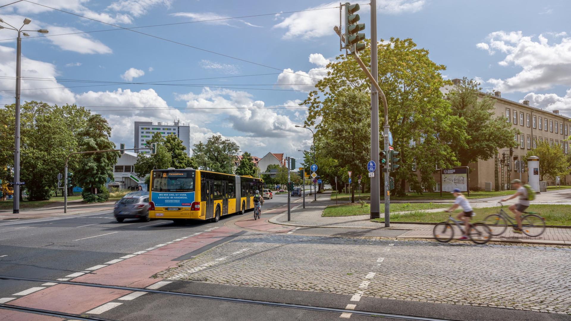 Straßenkreuzung mit Bushaltestelle und Radfahrenden