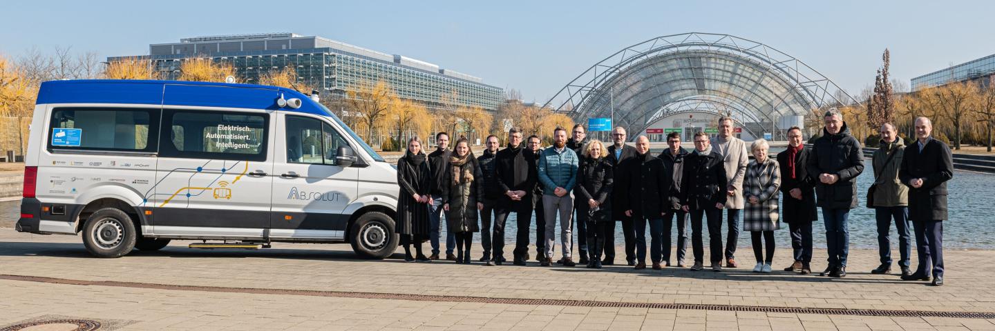 A group of people stand outside next to a van