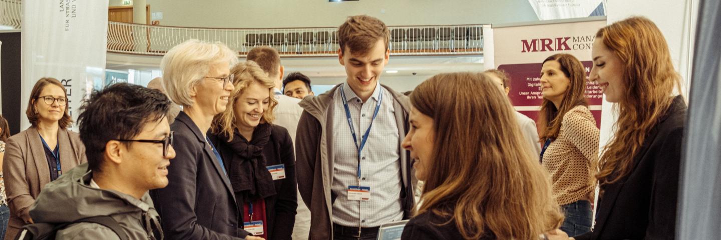 people talking at a fair stand