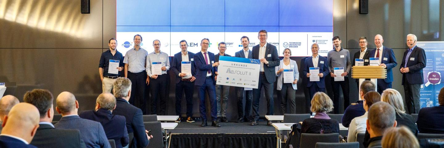 Group photo of all representatives of the ABSOLUT II project holding a funding certificate