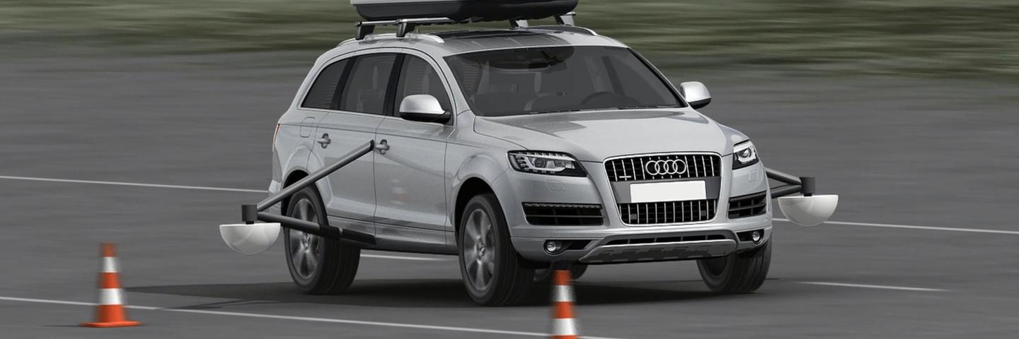 A car with a tilting frame and sensors on the left and right of the doors.