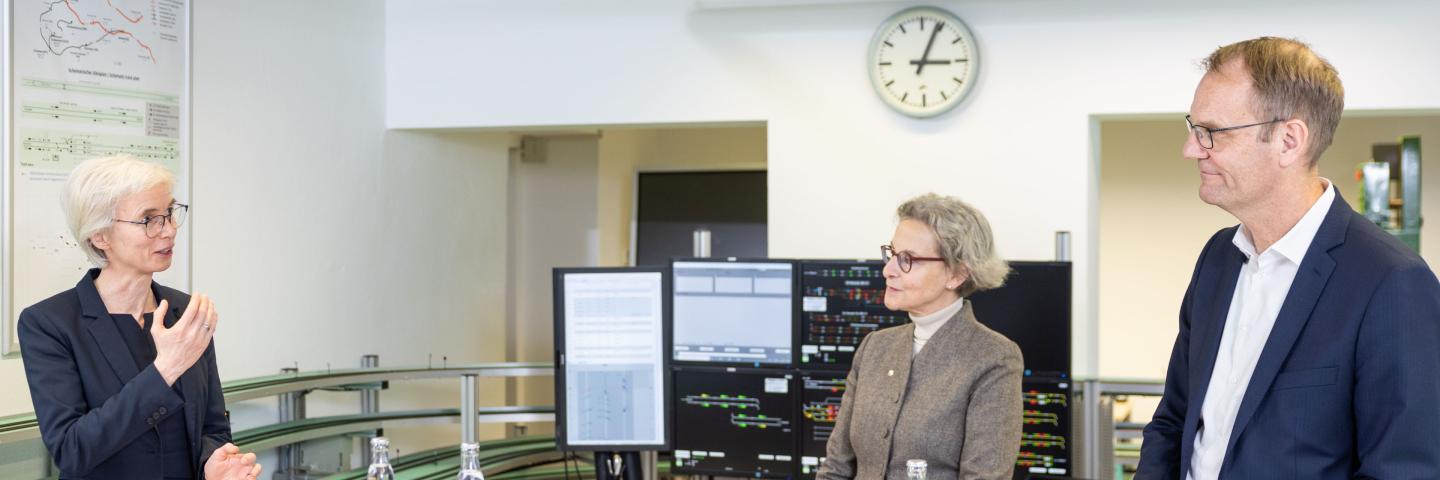Two women and a man standing in a laboratory