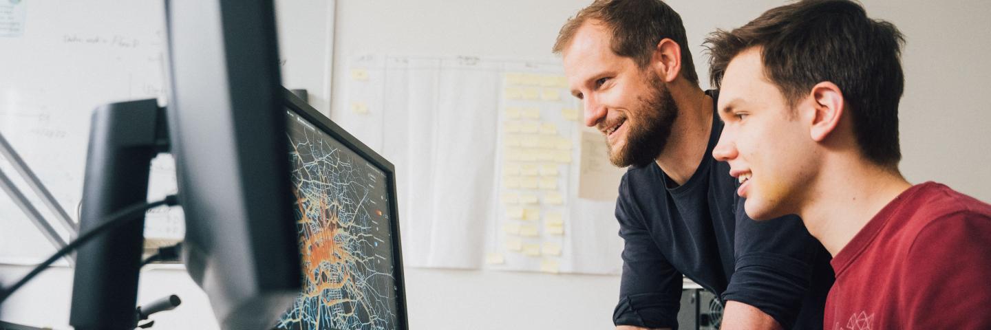 Two men looking at a computer screen