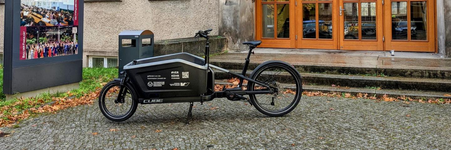 An e-bike parked in front of a university building