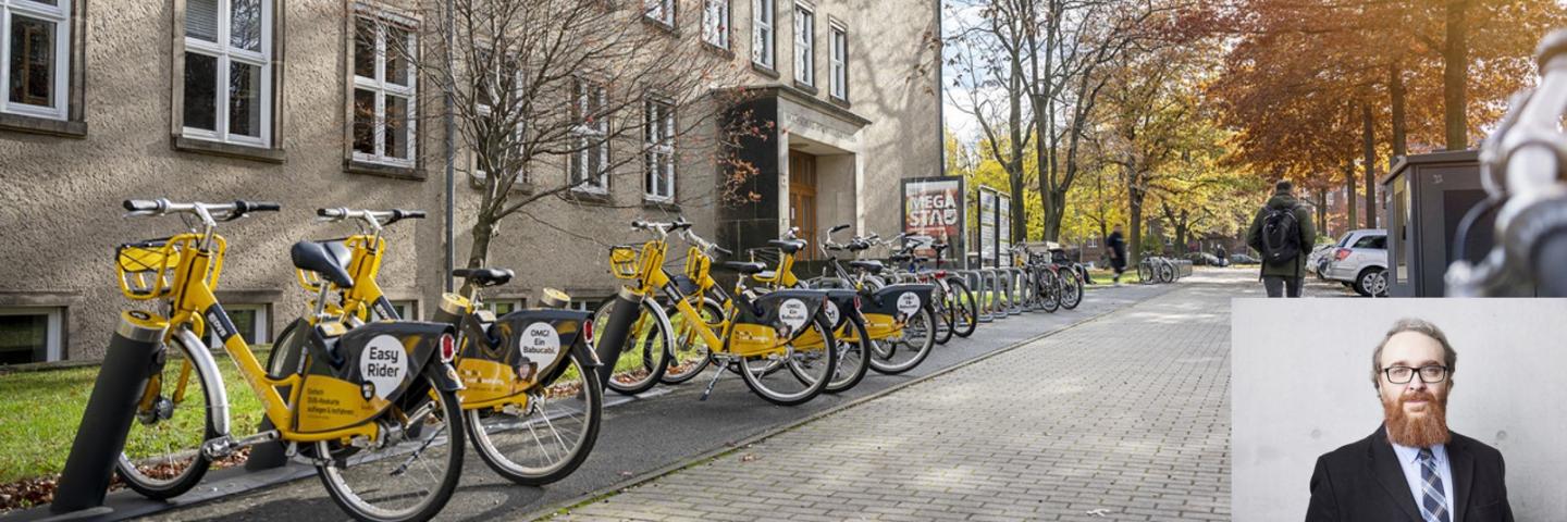 Gelbe Fahrräder vor einem Gebäude der TU Dresden. Unten rechts ein Porträt eines Mannes mit Bart.