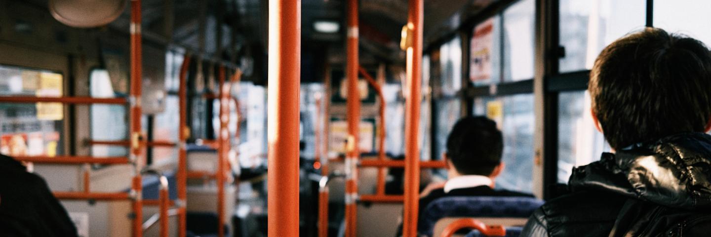 People sitting in a bus - view from the back